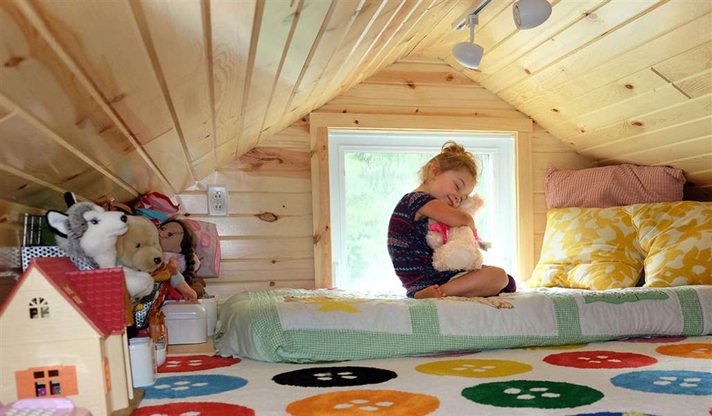 JaneRyeHugsStuffedAnimalInTinyHouse-postedMHLivingNews-