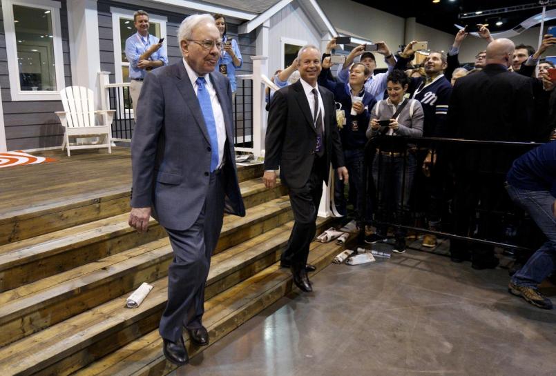 Berkshire Hathaway CEO Warren Buffett walks with Kevin T. Clayton, CEO of Berkshire Hathaway subsidiary Clayton Homes, out of one of the company's houses prior to the Berkshire annual meeting in Omaha